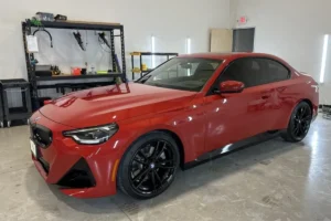 Red car inside a detailing shop with glossy polished finish