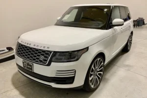 Front view of a white Range Rover, highlighting its grille and elegant styling
