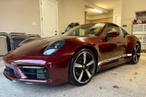 Front view of a red Porsche with vinyl wrap, showcasing a smooth, polished finish.