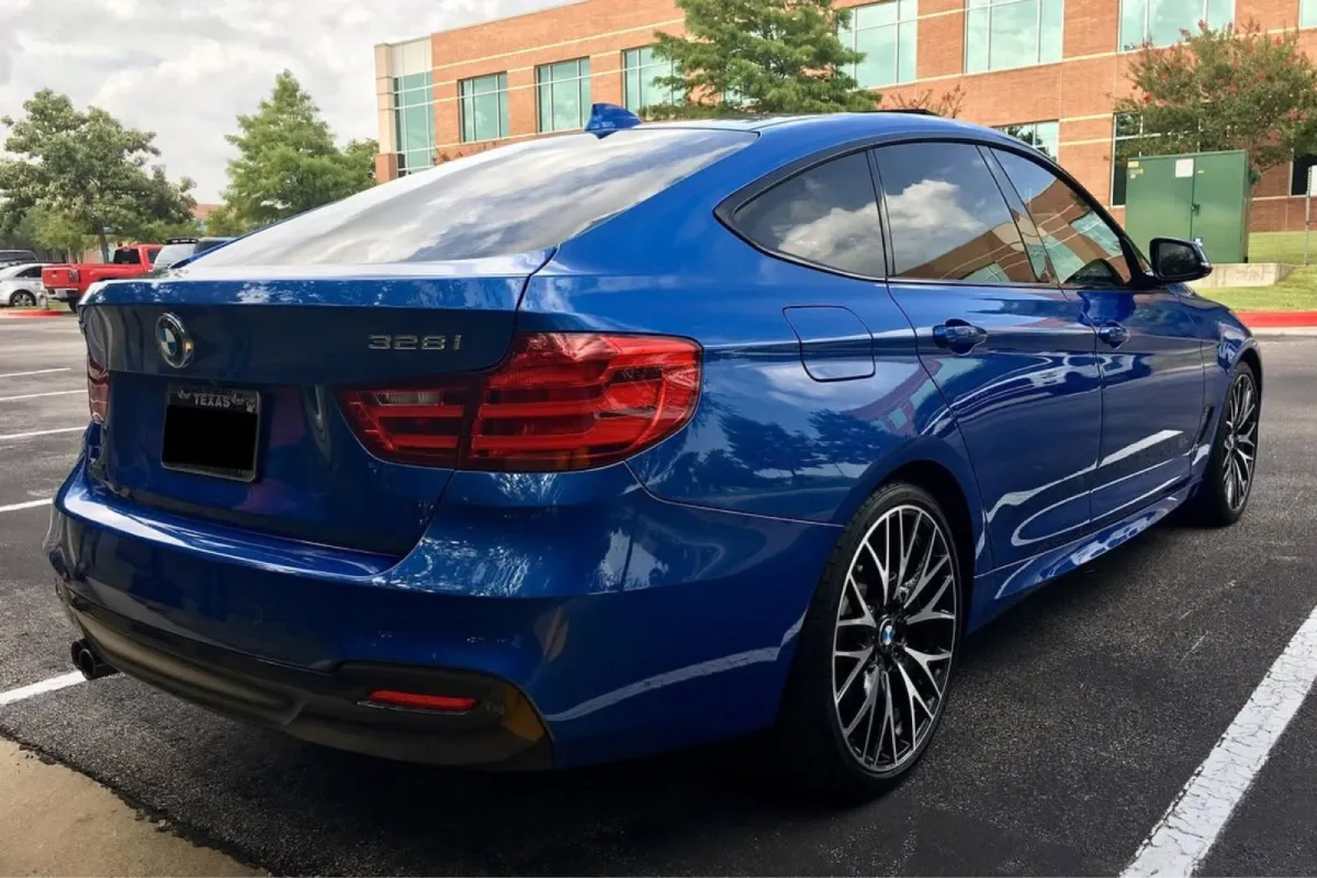 Rear side view of a blue BMW after paint correction.