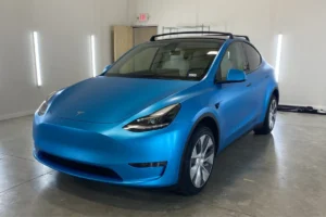 Tesla Model Y finished in a satin blue vinyl wrap.