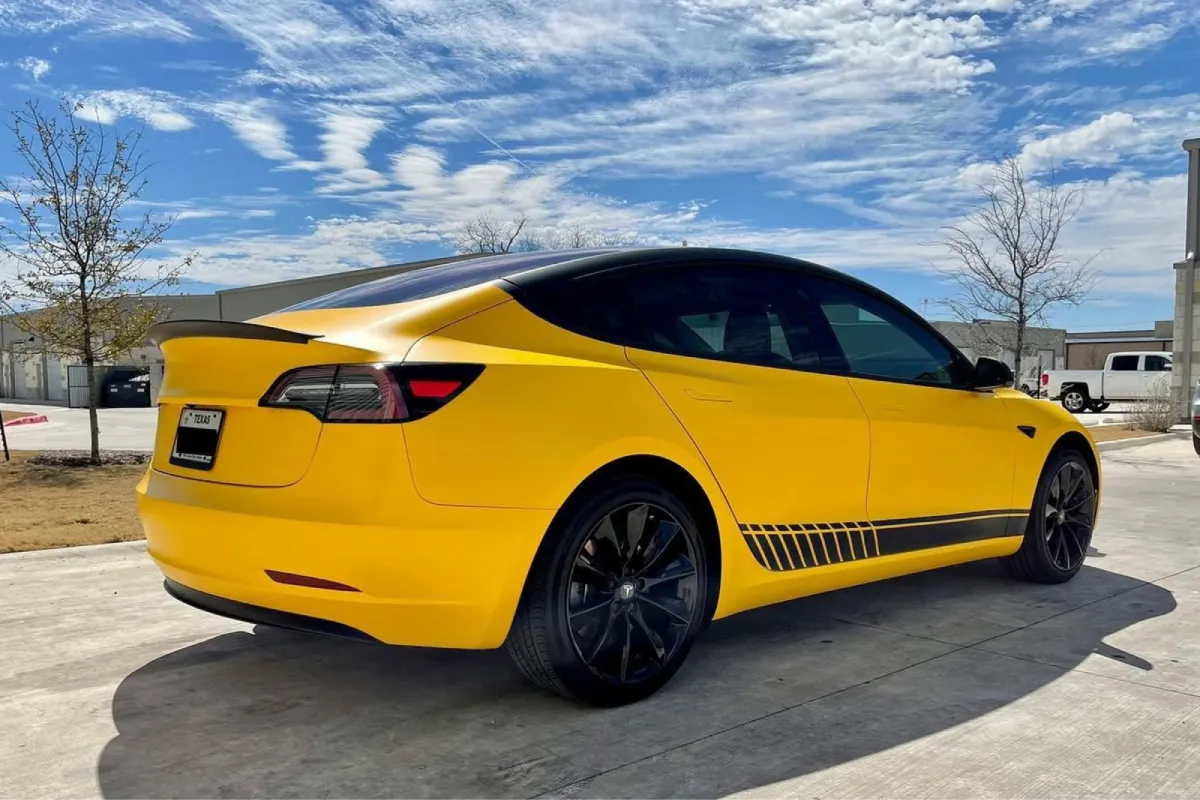 Yellow Tesla Model Y showcasing a finished vinyl wrap.